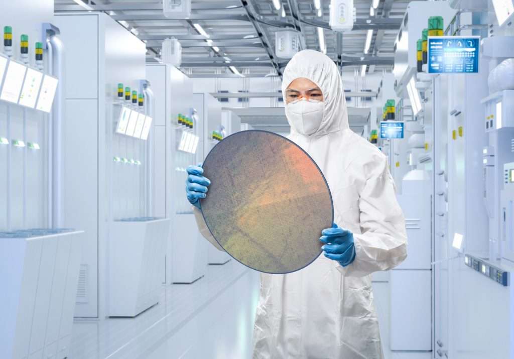 Employee carrying a silicon wafer in compliance with the ESD 20.20 Standard