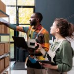 Electronics supply chain manager reviewing just-in-case inventory buffer strategy on digital dashboard